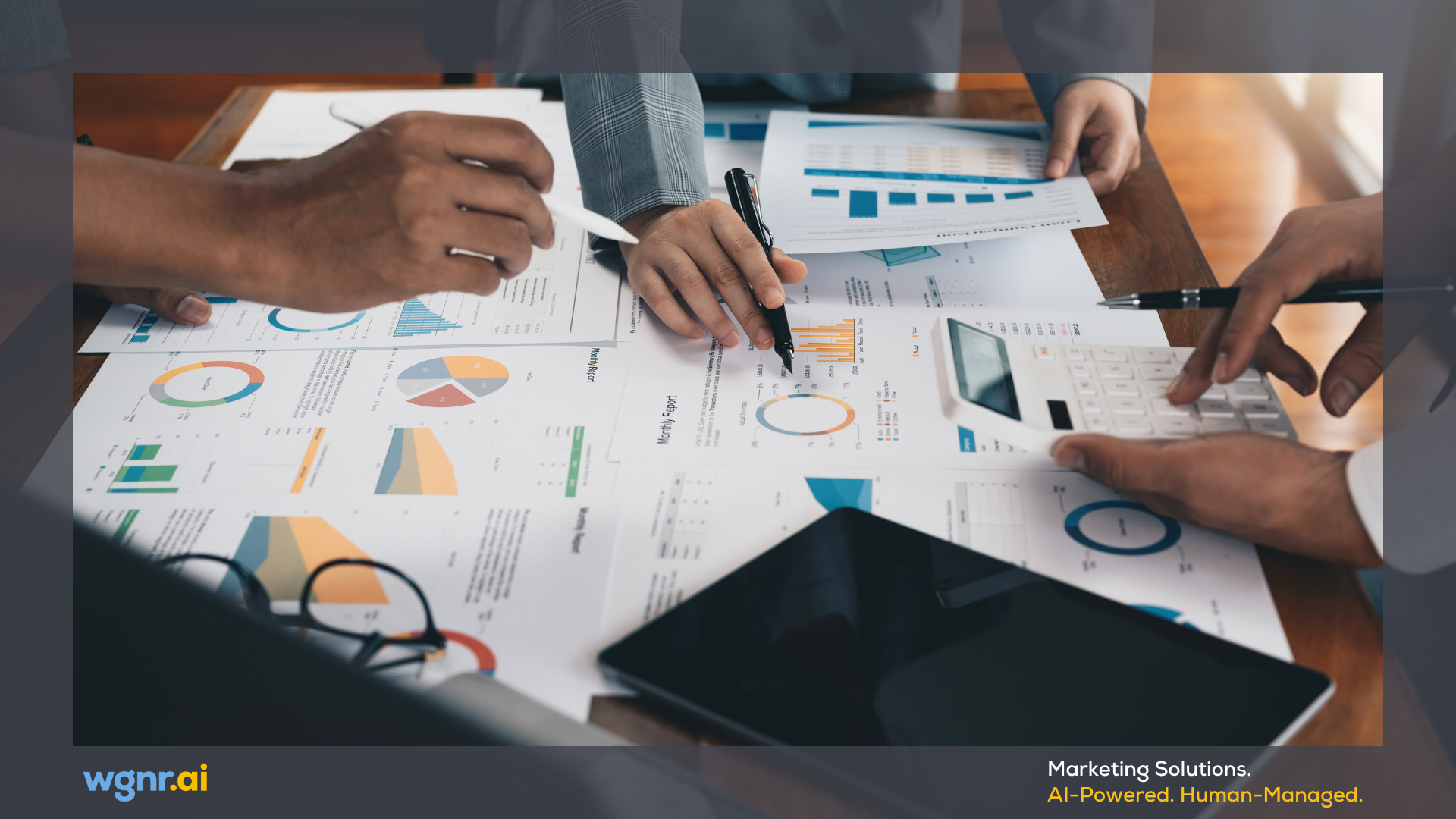 Hands analyzing financial charts and graphs on paper.